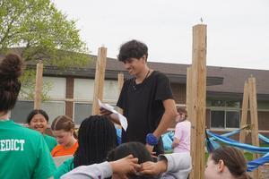 A student helps with a game at Page Elementary.