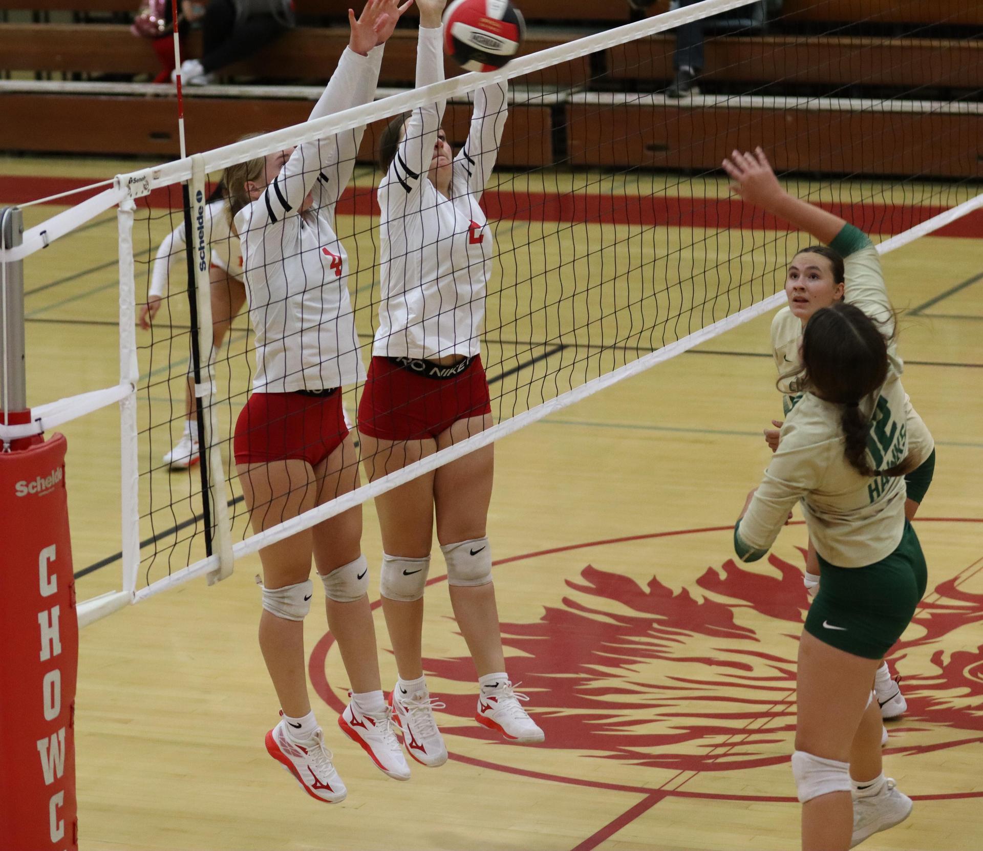 varsity volleyball players in action against liberty