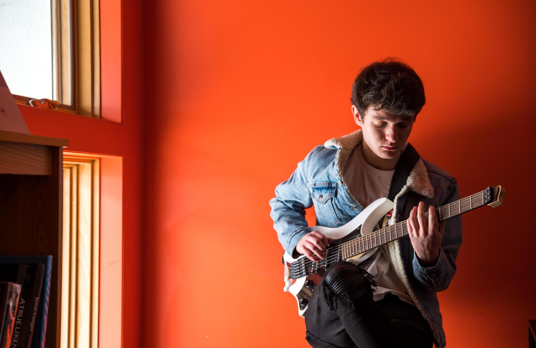 A student playing the guitar.