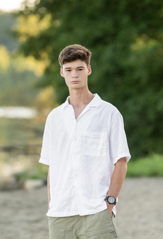 Student is standing on business in a white dress shirt and khakis