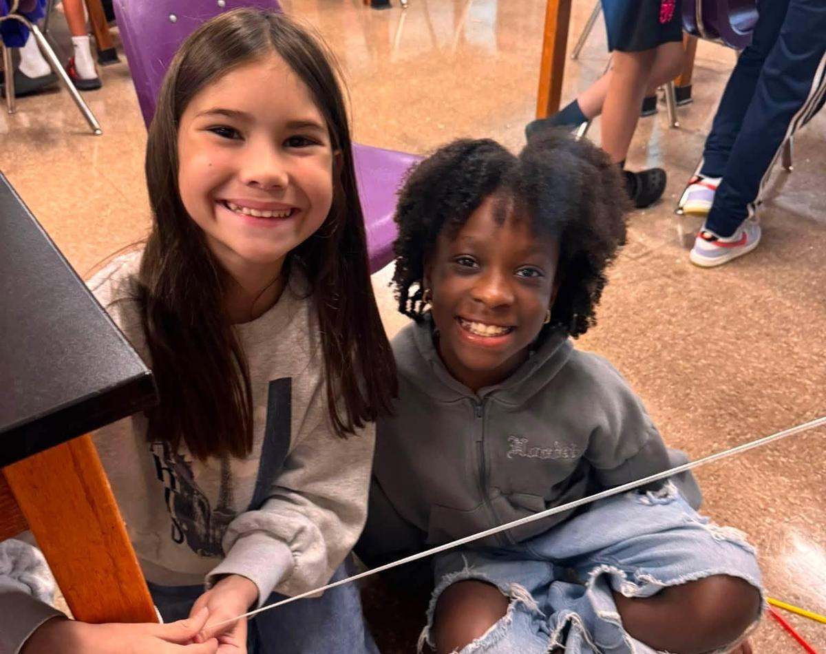 JIS students pause for a photo during a hands-on learning project