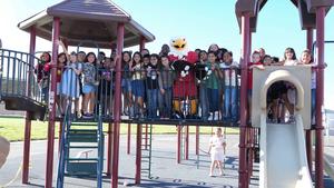MSJC mascot, Ernie the Eagle on playground equipment with group of students