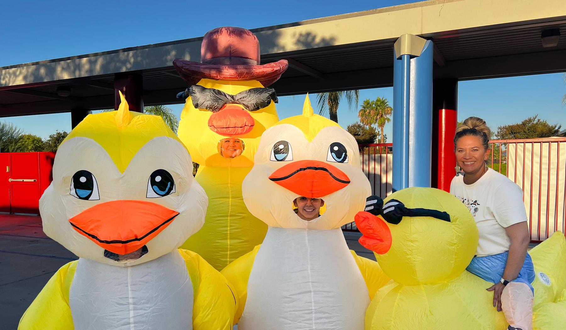 four staff members in inflatable duck cosutmes