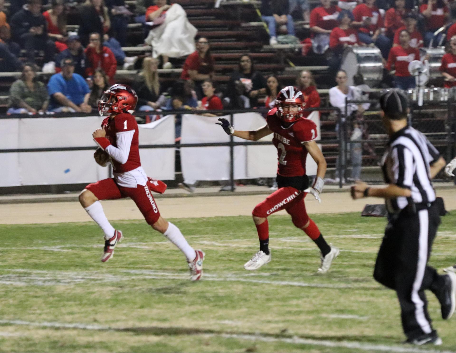 varsity football players in action against Riverdale