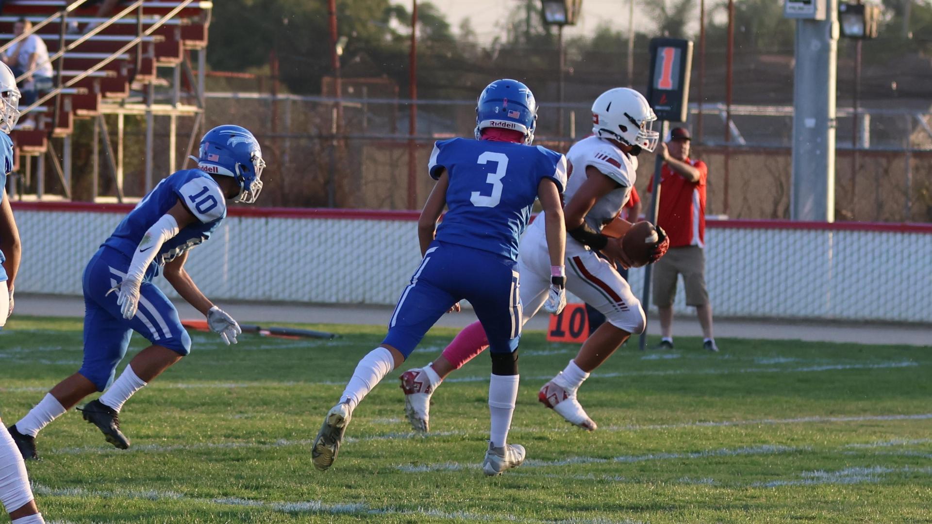Junior Varsity football players in action against Caruthers
