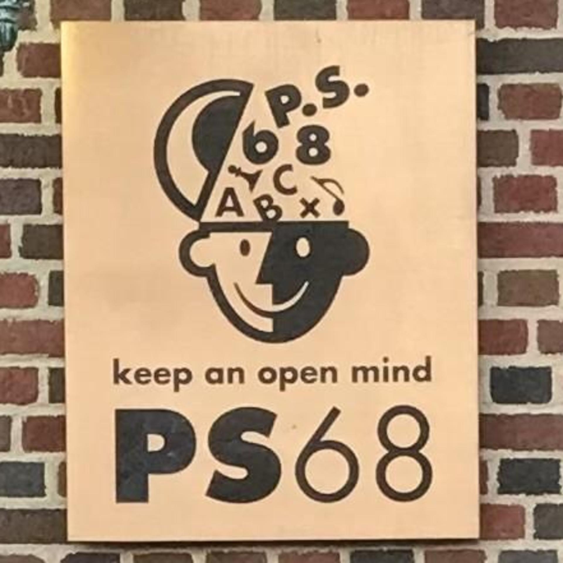 Brass plaque of school name and logo