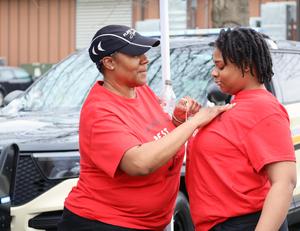 woman applies sticker to shirt