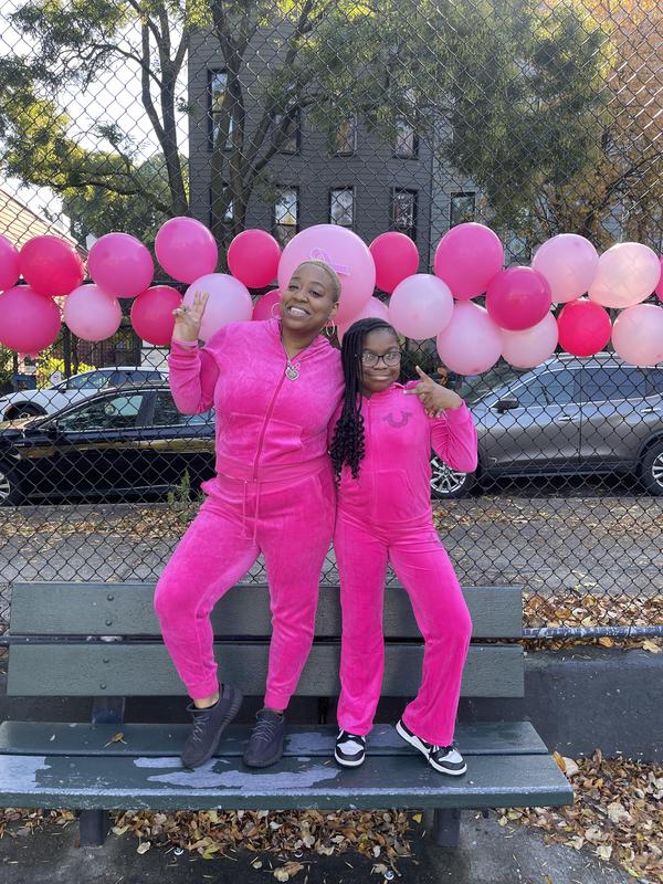 Staff and student in all pink jump suit