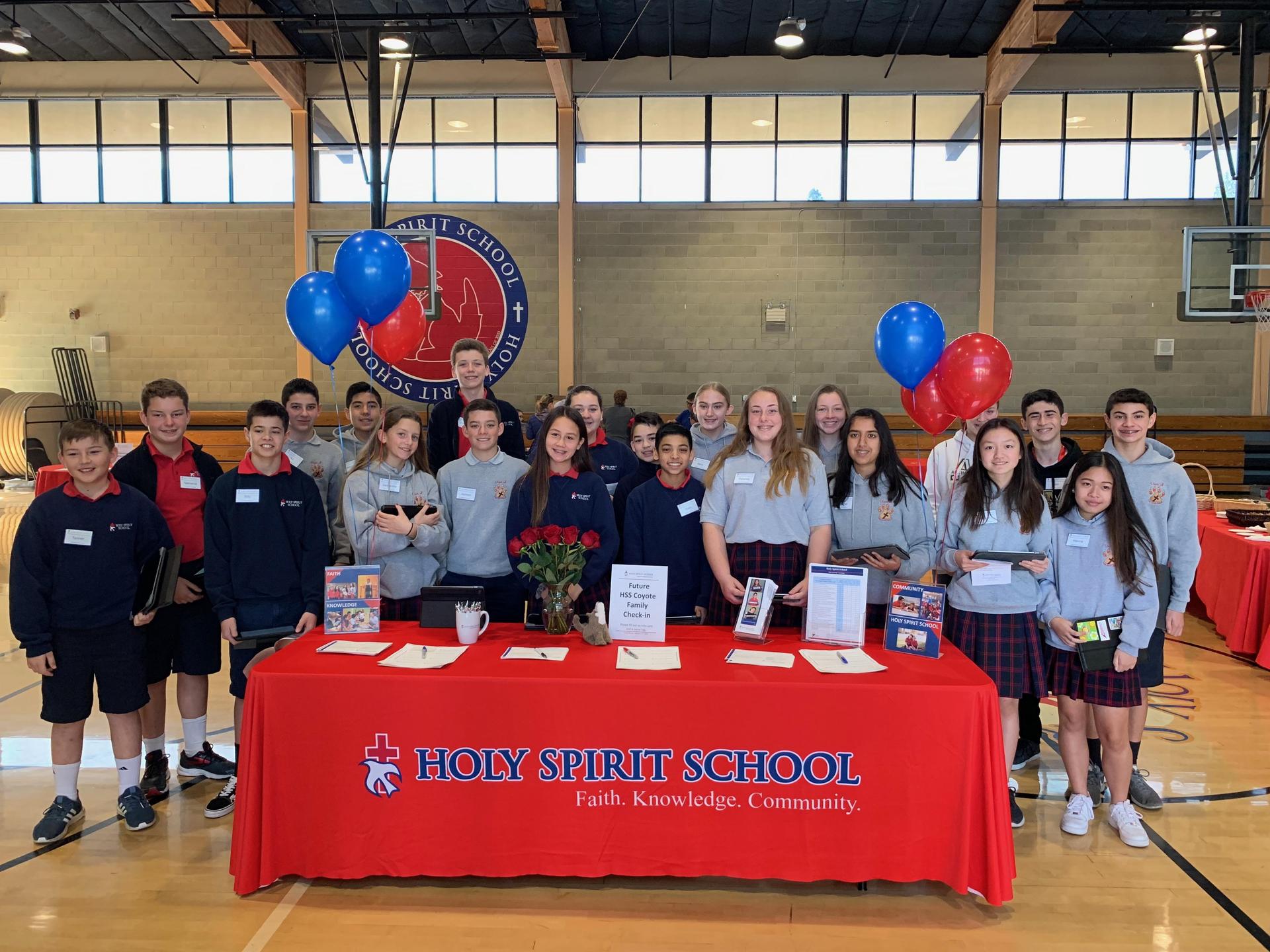 students at open house welcome table