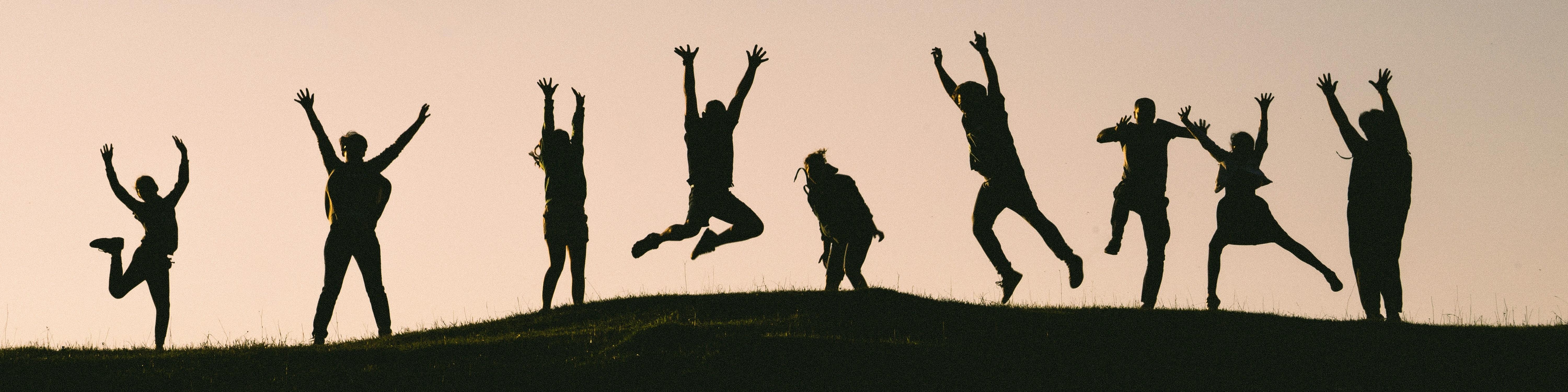 People Jumping on a hill