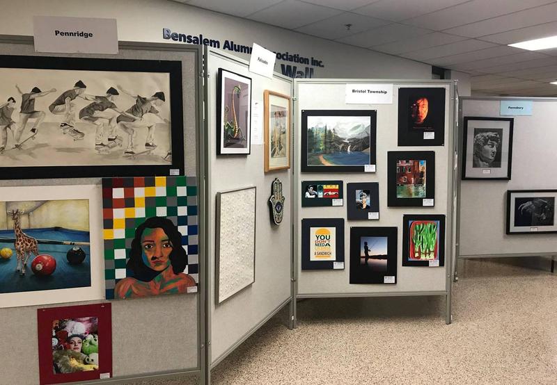 Artwork from Pennridge, Palisades, Bristol Township and Pennsbury School Districts featuring Black and white sketch of skateboarders, Giraffe on a pool table, Green dragon, and a Boy fishing.