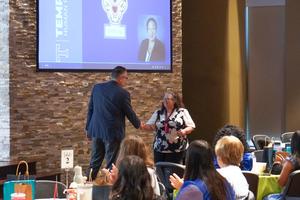 Dr. Bobby Ott greets a new teacher during new teacher induction