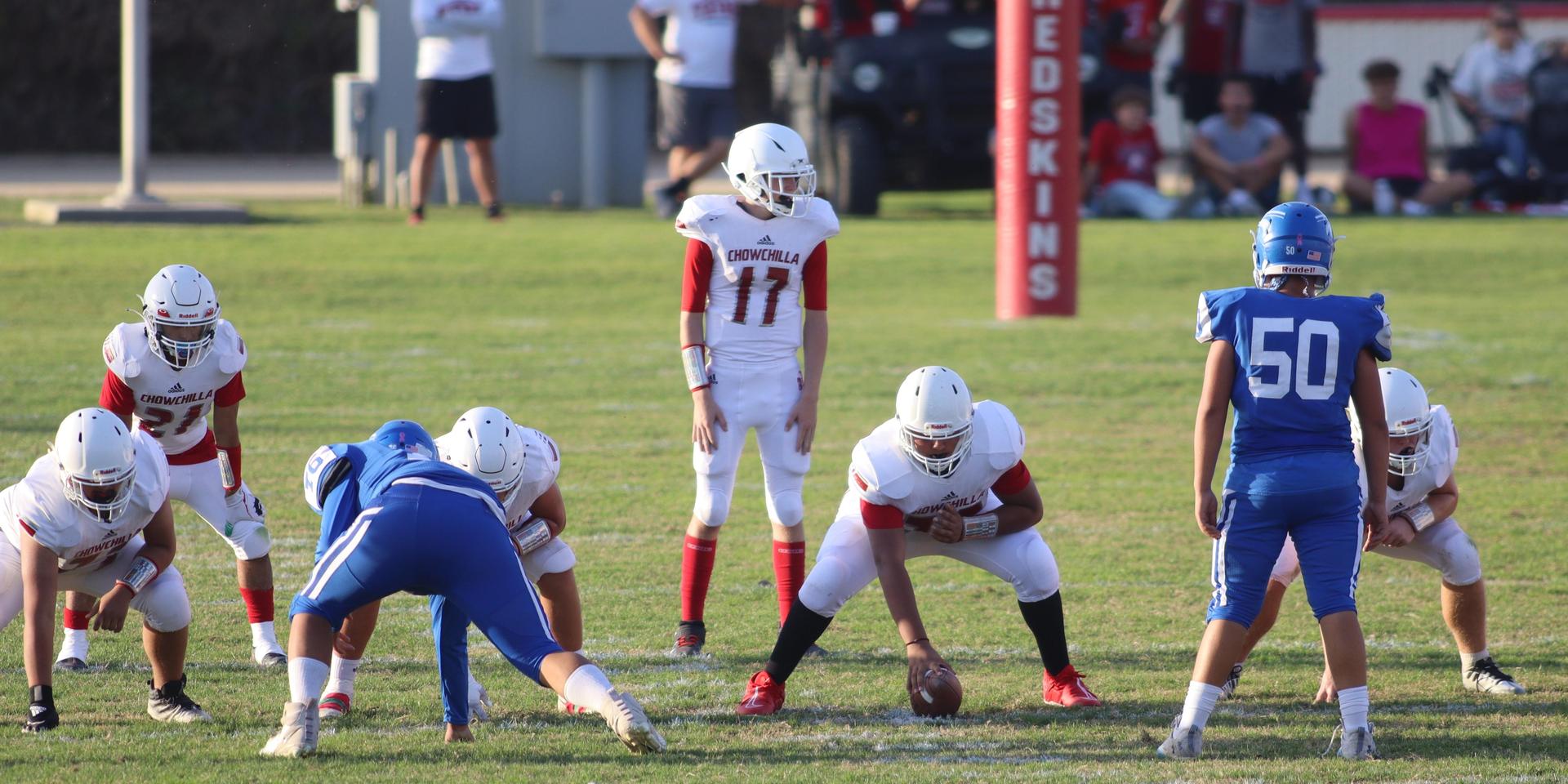 Junior Varsity football players in action against Caruthers