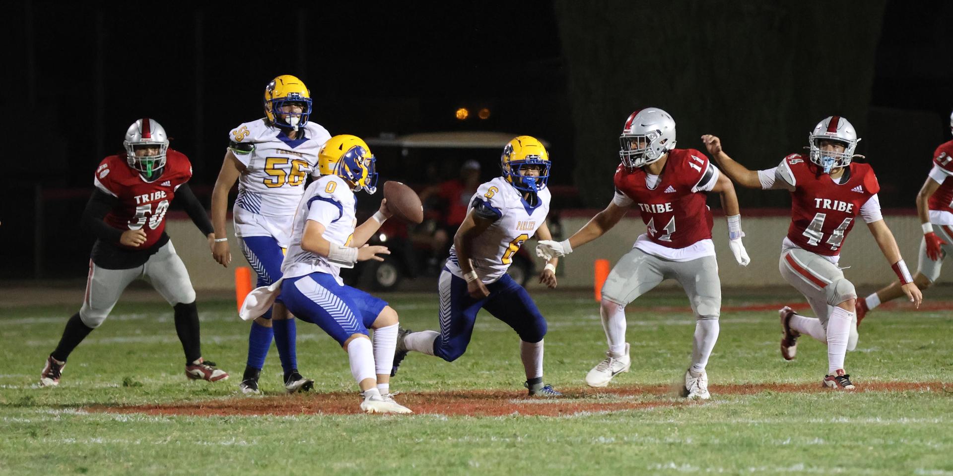 Varsity football players in action against Parlier 37