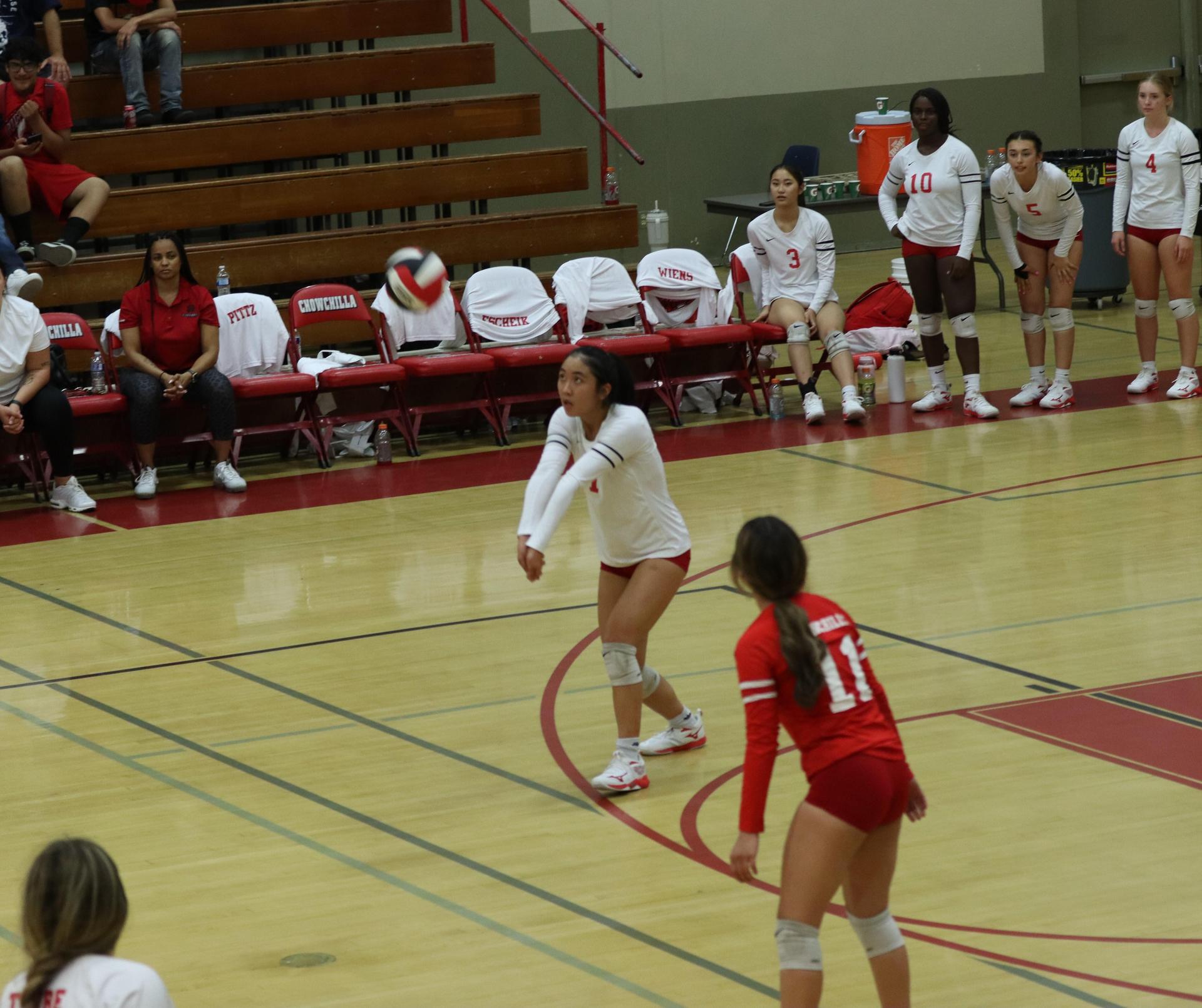 varsity volleyball players in action against liberty