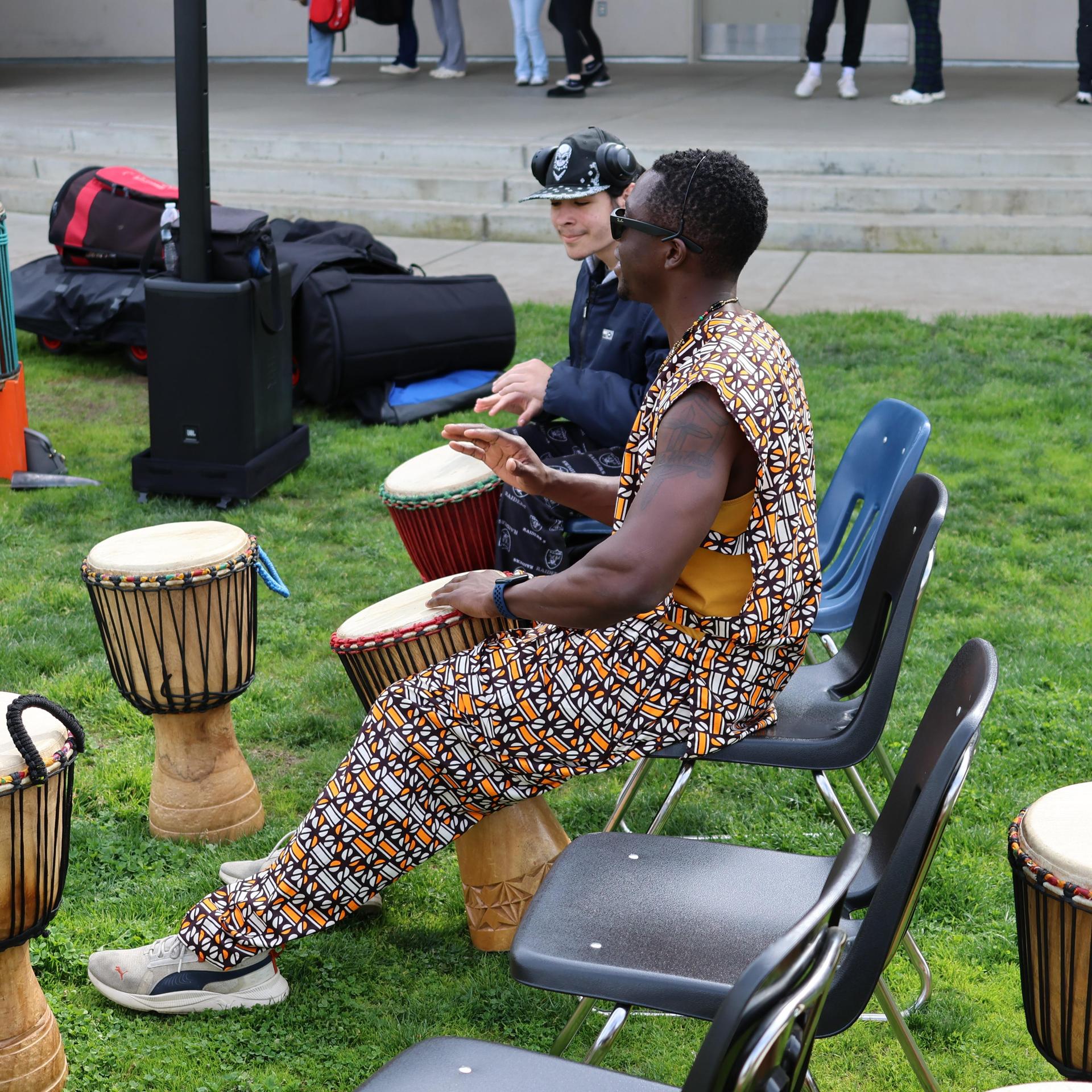 students and staff participating with the African Drum Interactive