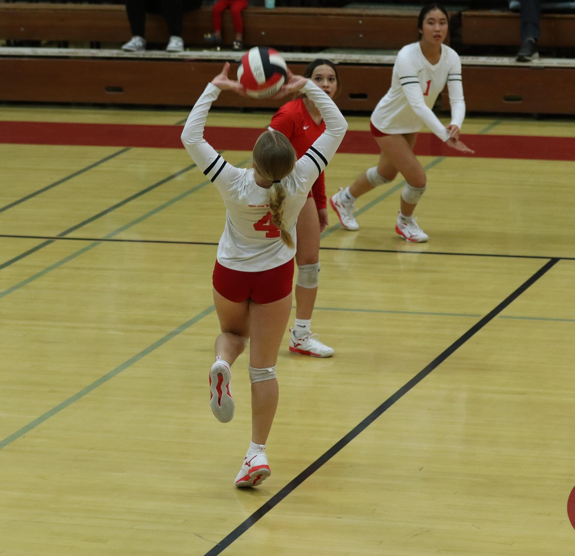 varsity volleyball players in action against liberty