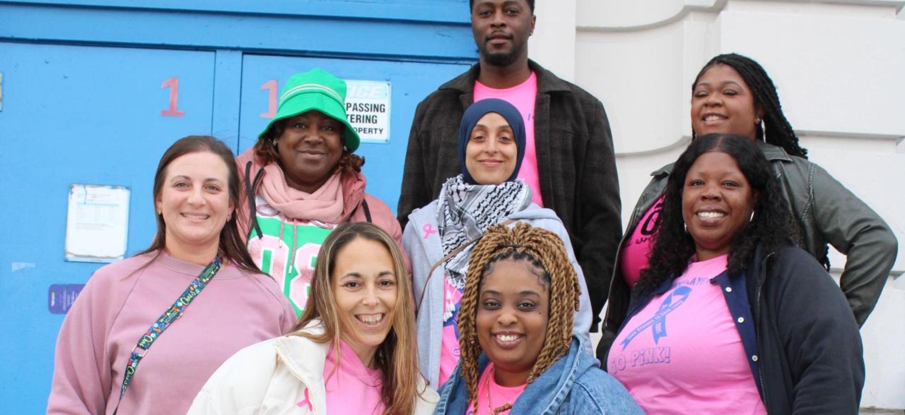 Teachers take photo in front of school for breast cancer awareness