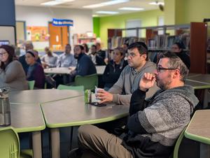 Parents listening to the presentation.
