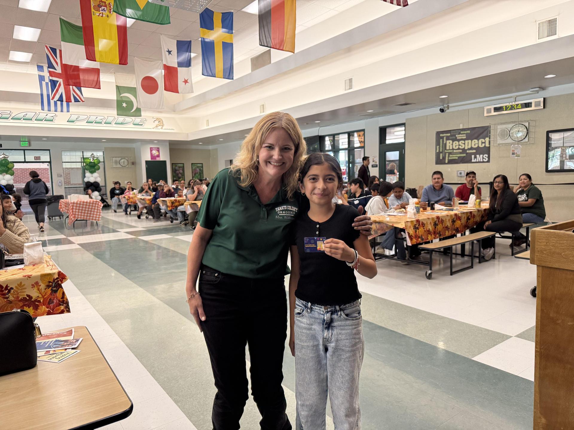 Principal posing with student