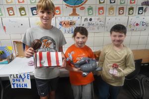 Students show their gourd projects.