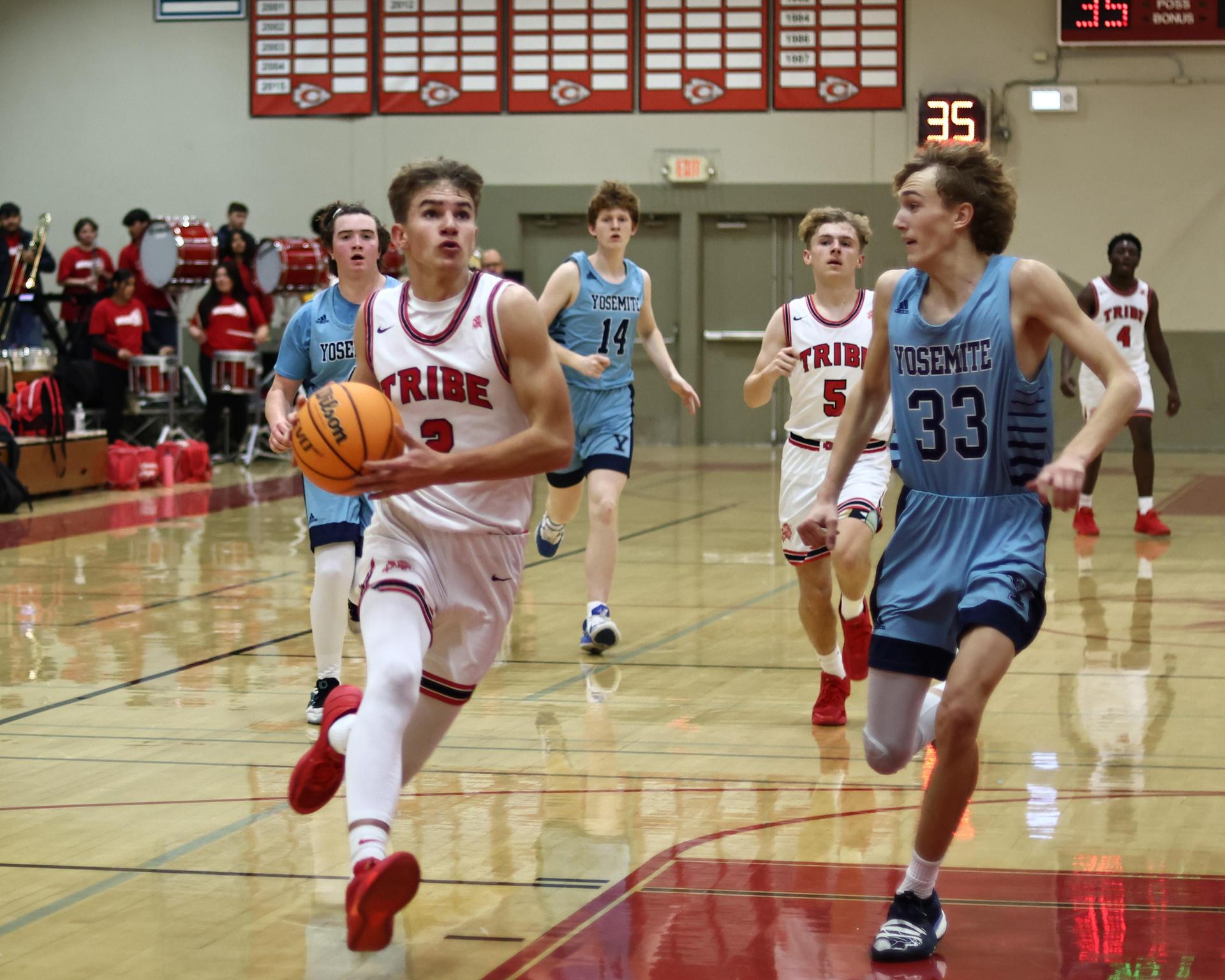 Varsity boys playing basketball against yosemite