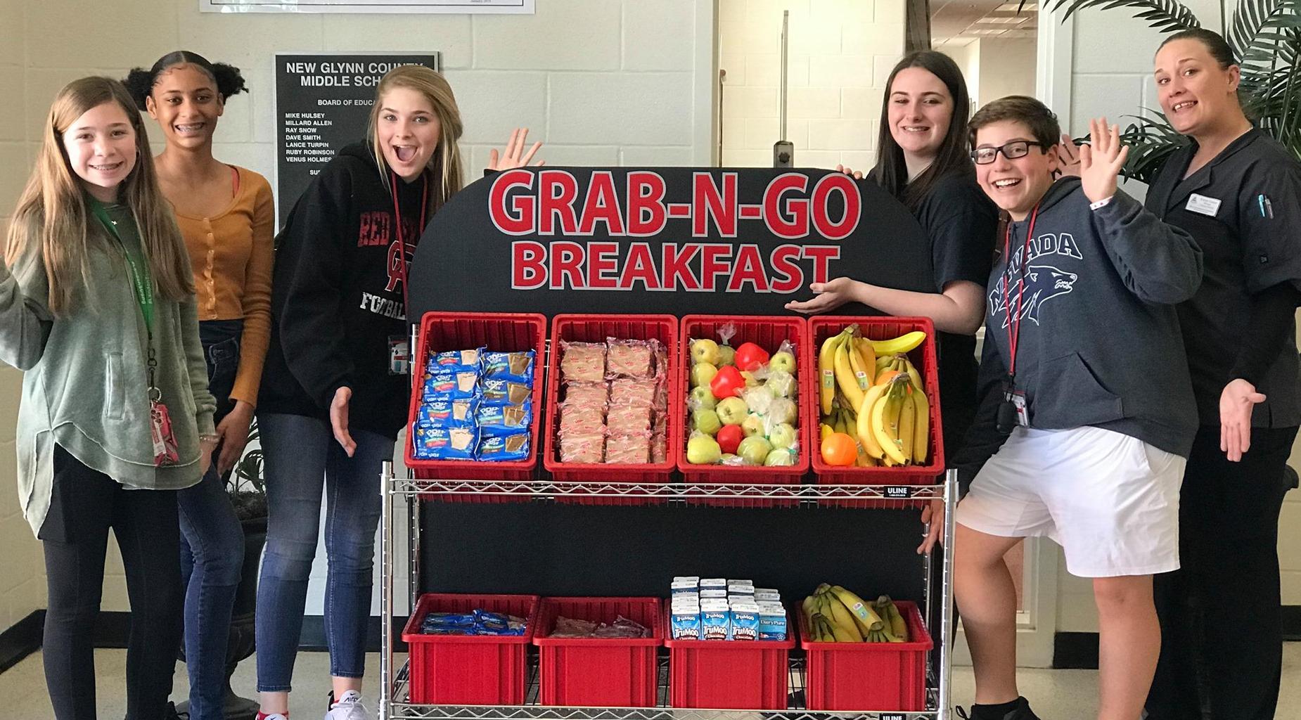 Students pose with Grab 'N Go carts.