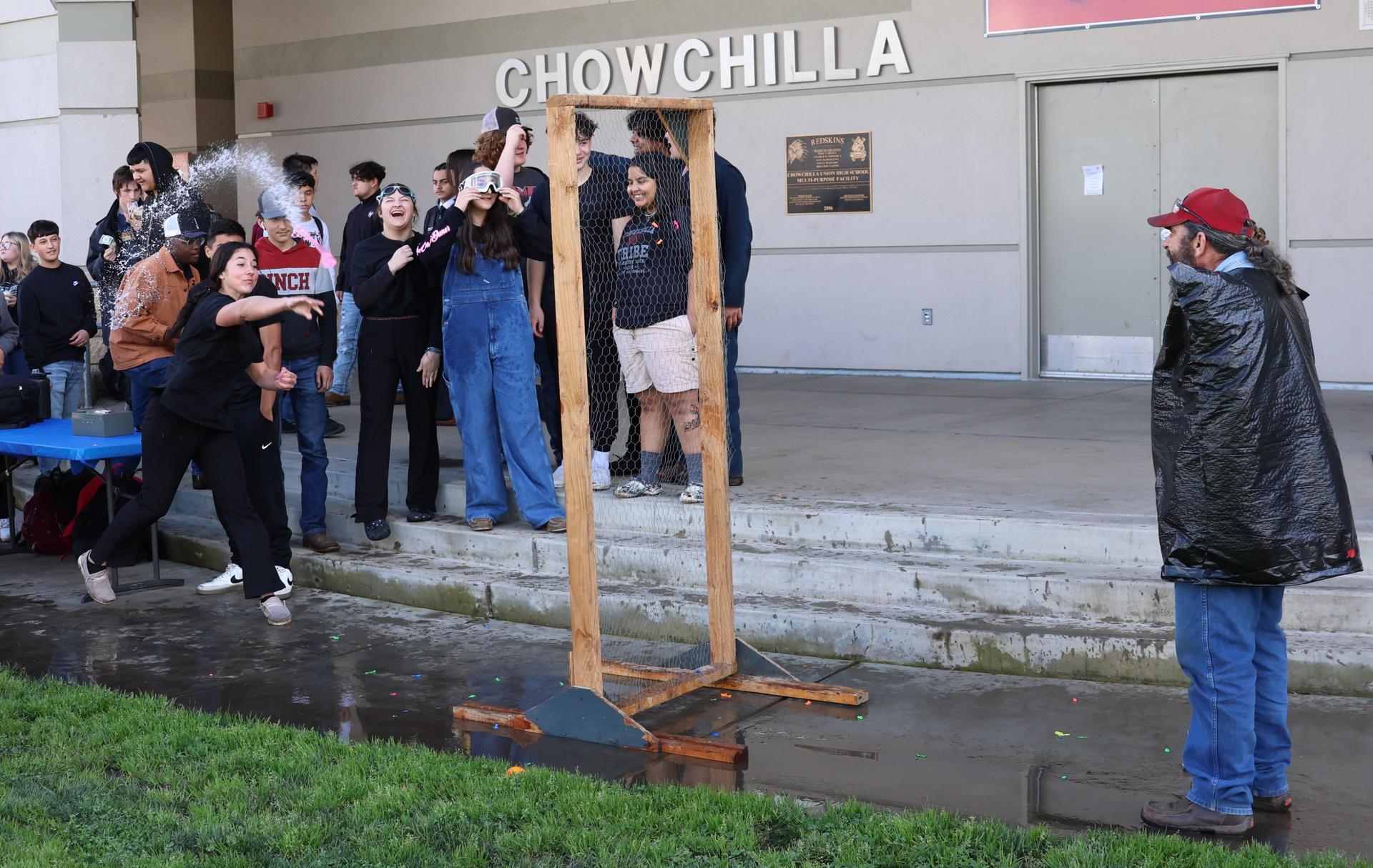 students and staff enjoying the water balloon toss