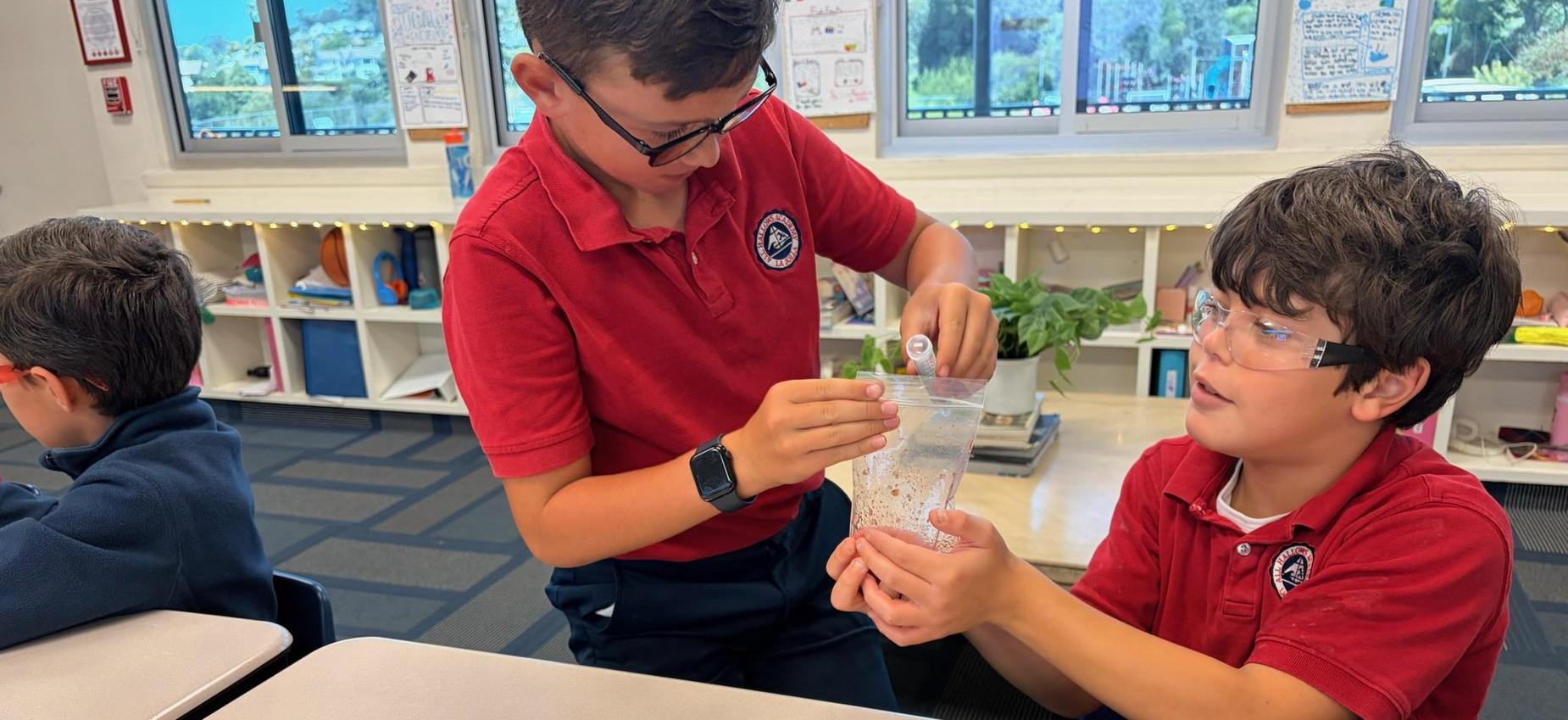 two 4th grade boys working together on science lab