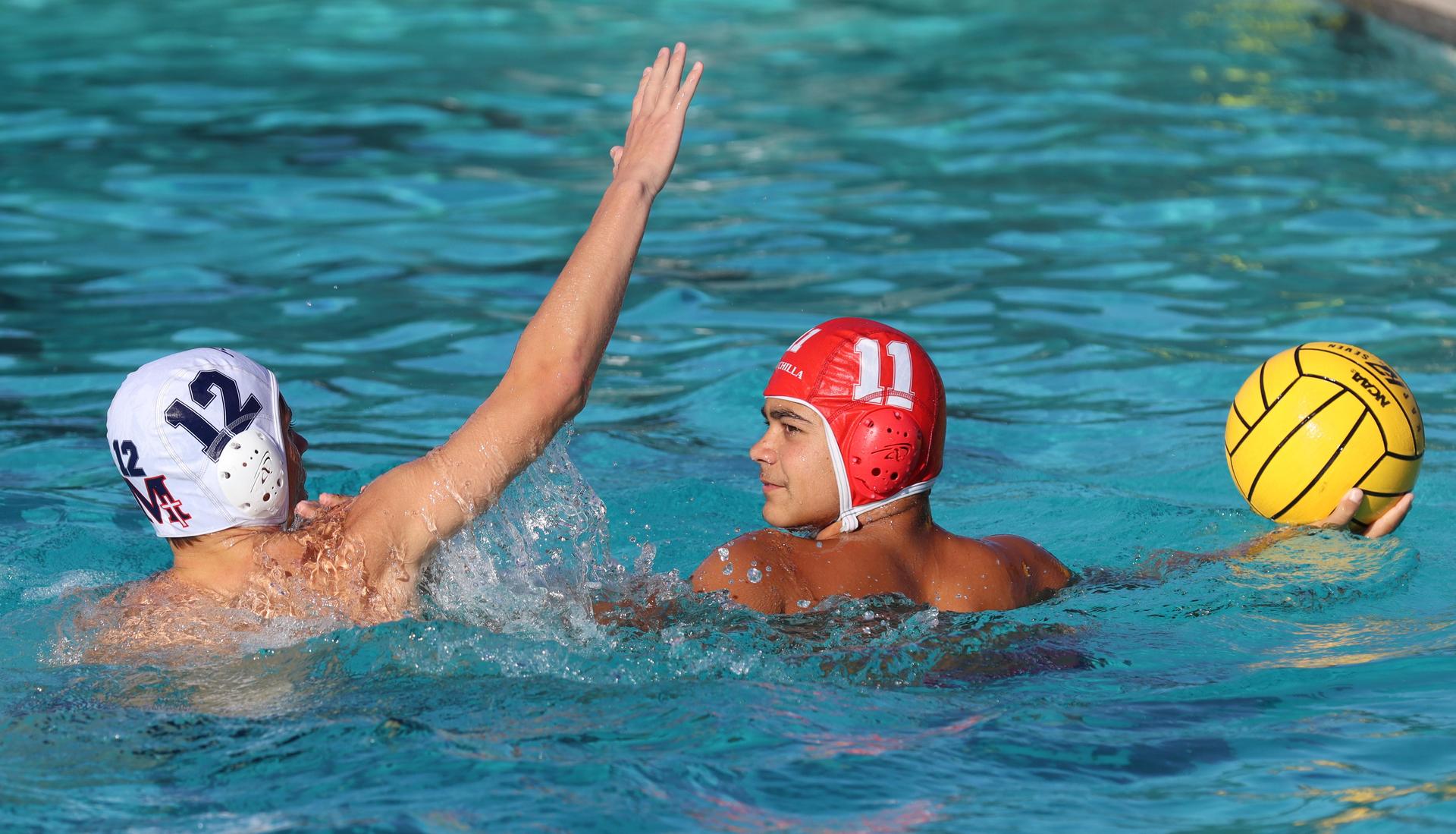 boys water polo players in action against san joaquin memorial