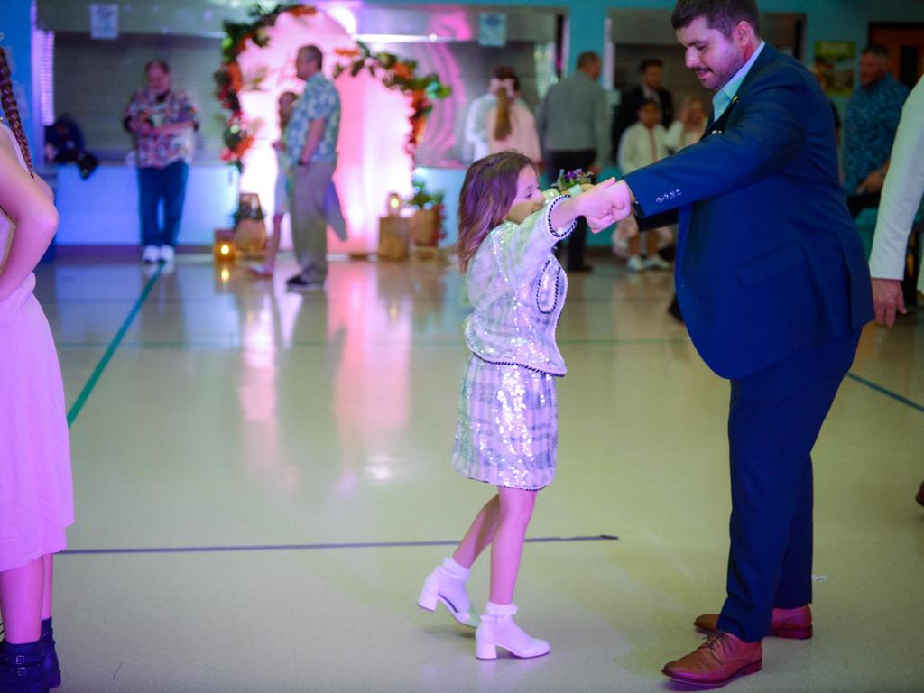 A dad and his daughter dancing.