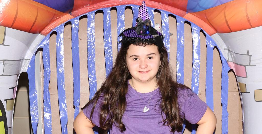 Girl with purple shirt and black skirt.