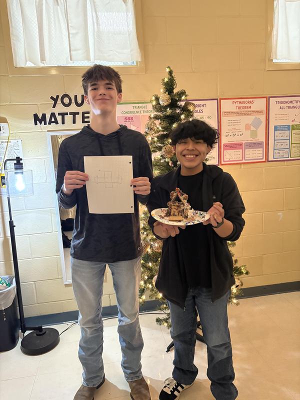 two students with gingerbread house