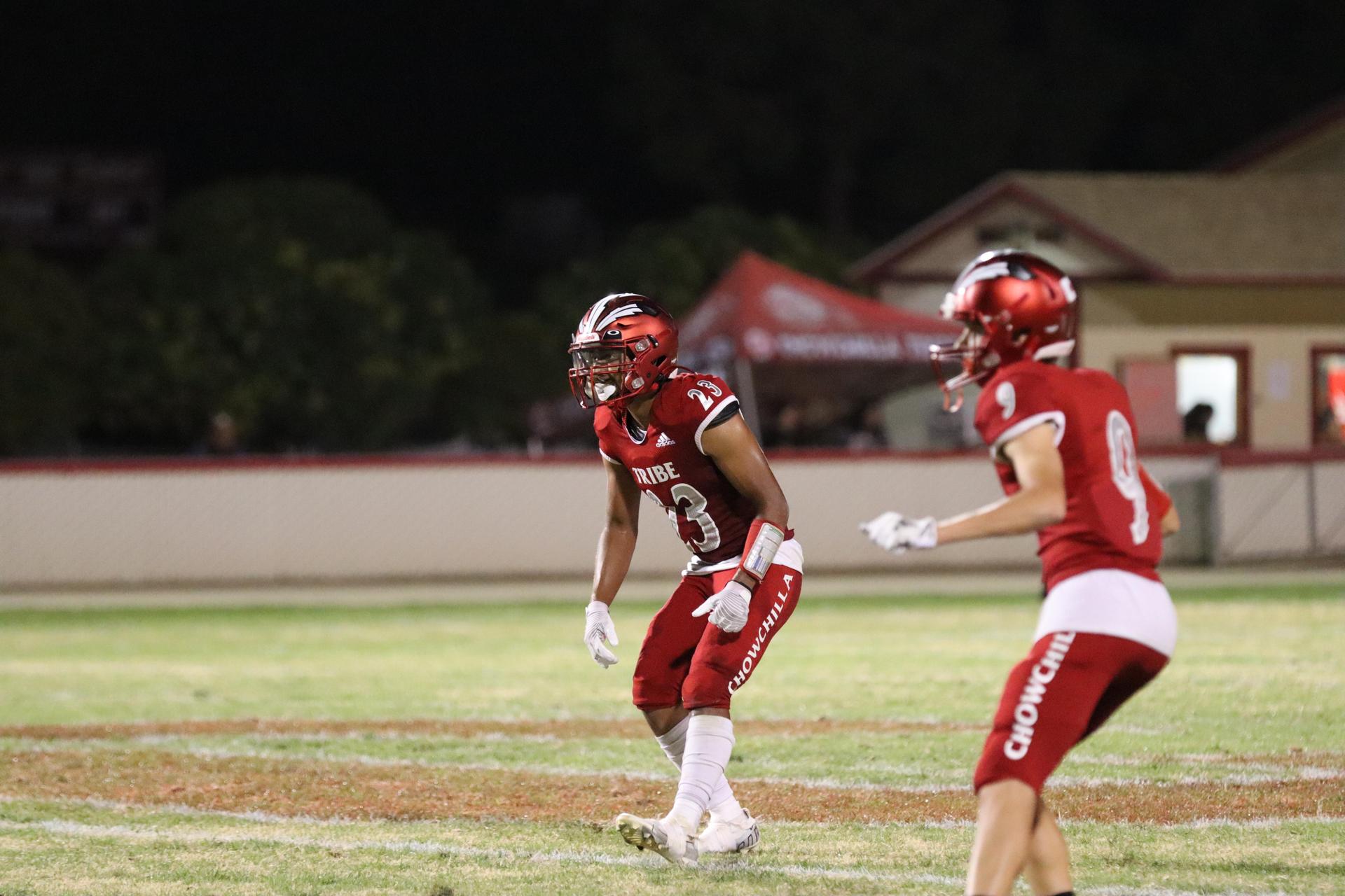 varsity football players in action against Riverdale