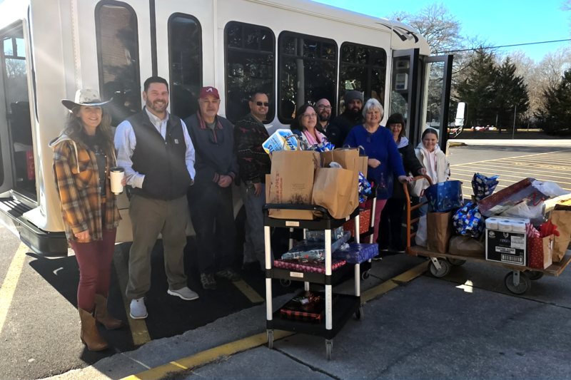Members of the N.B. Clements Junior High School counseling team, their building principal Matt Weston, and members of Oakland Baptist Church present an assortment of donations to benefit students and families at the school during the holidays.