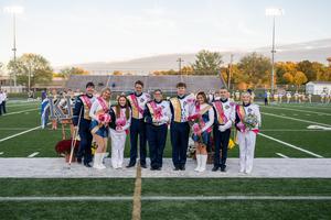 Members of a band standing in a row on a football field