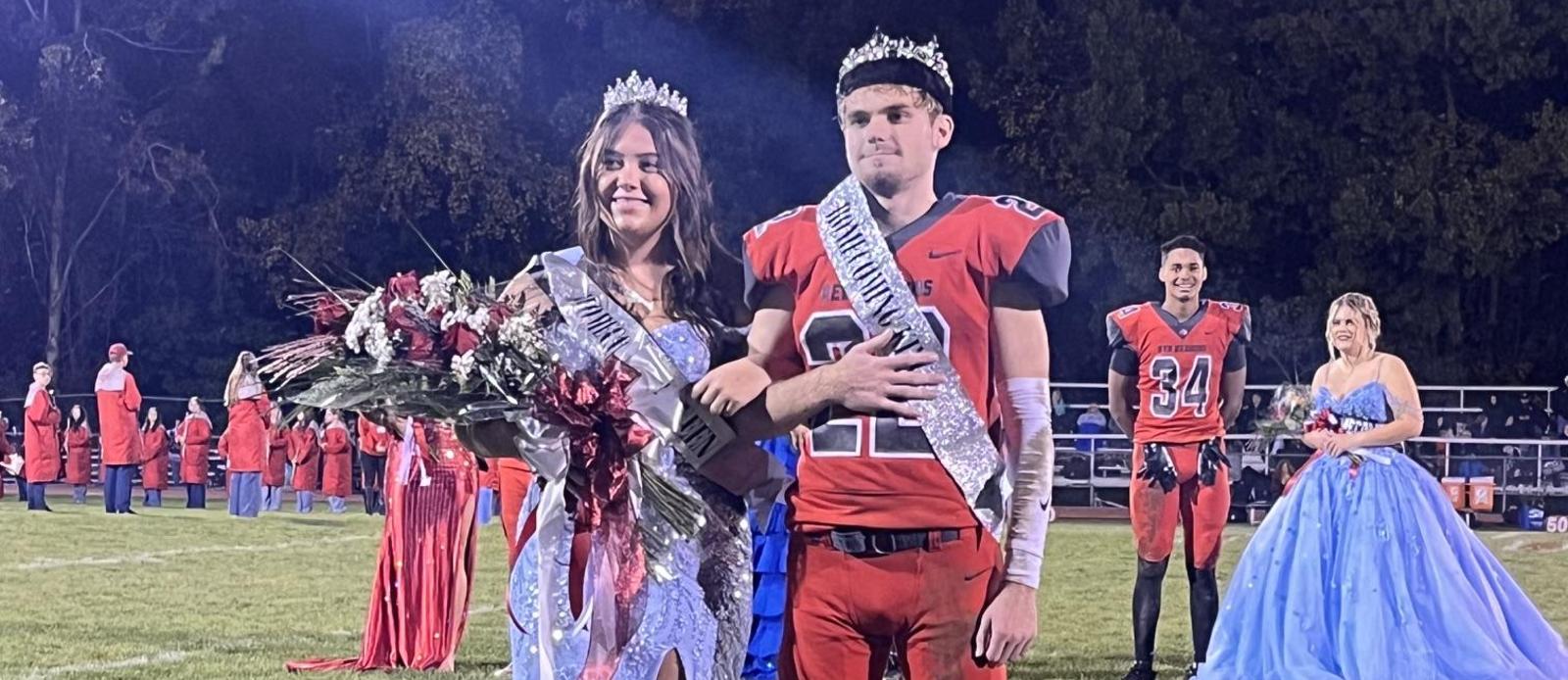 Homecoming Queen and King standing on football field