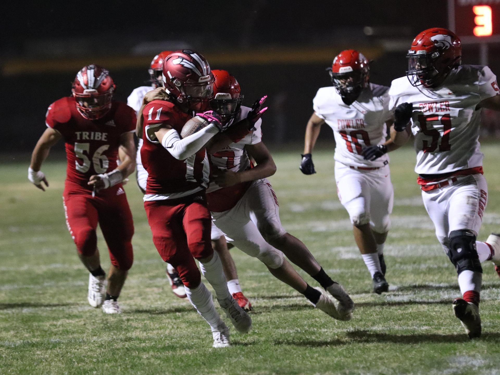 varsity boys playing football against Fowler