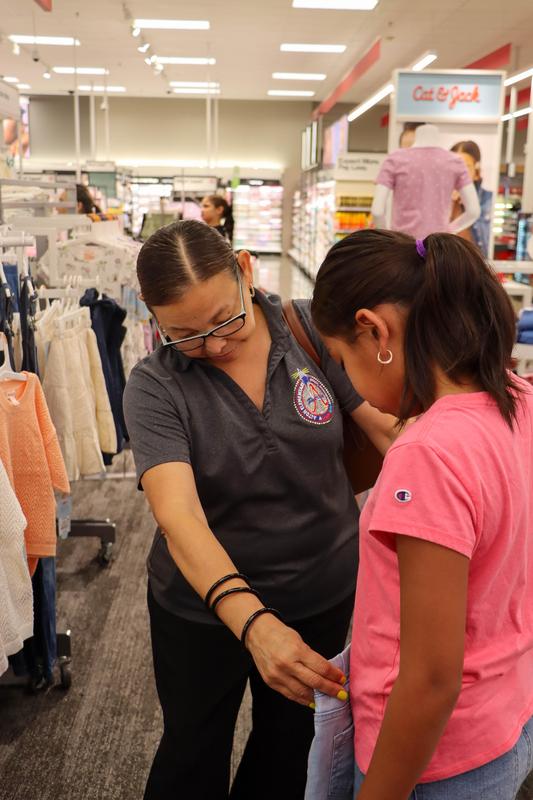MCISD Parent Liason helping a student with picking out clothes