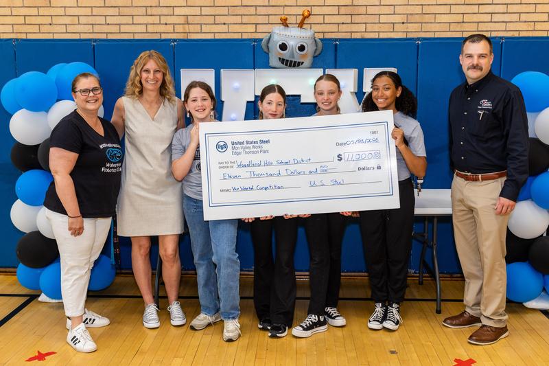 Ms. Dietrich, Dr. Livingston, Mr. Hannigan and the Robotic Wolverines with the donation