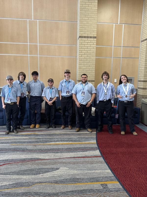 Smiling students with awards