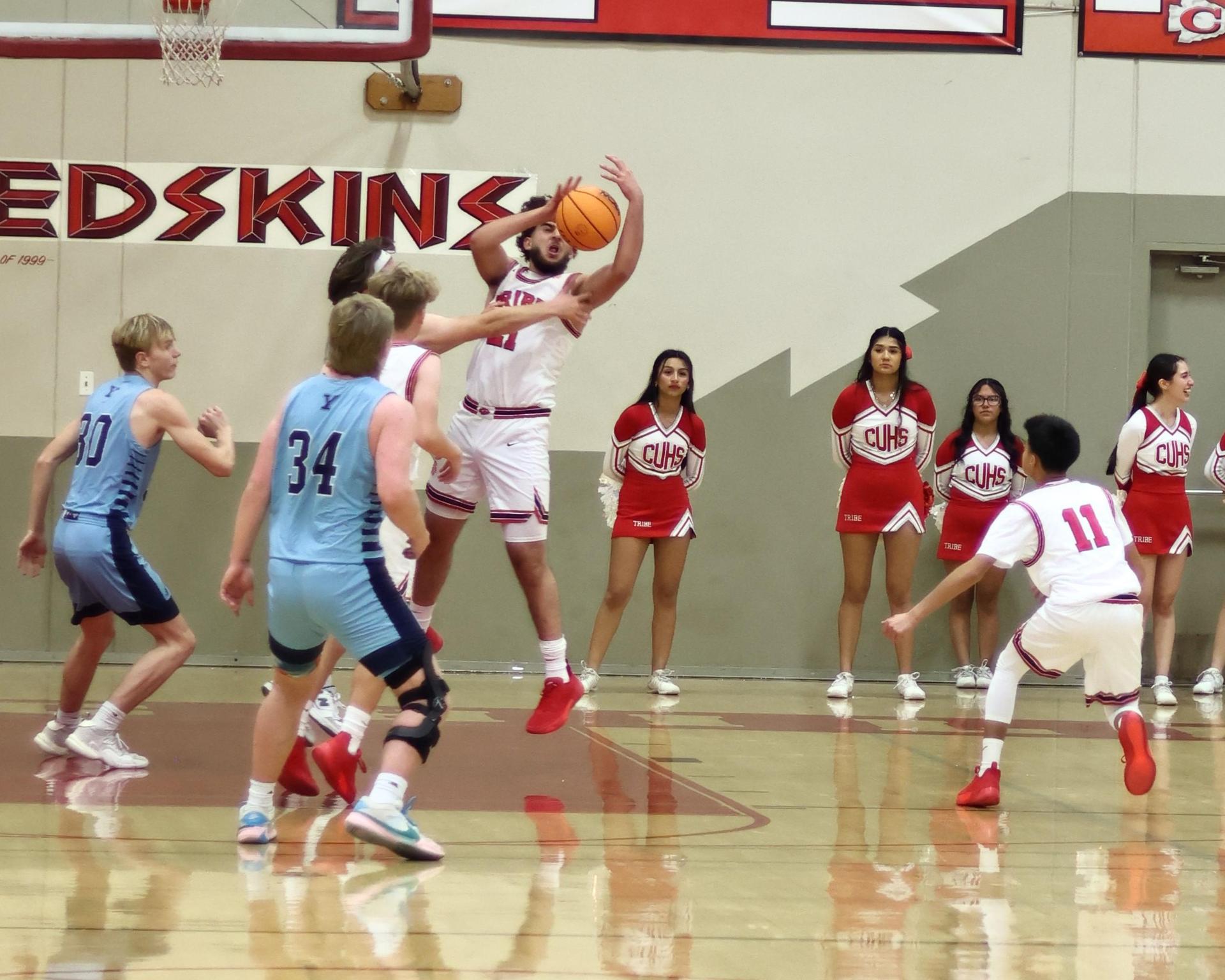 Varsity boys playing basketball against yosemite