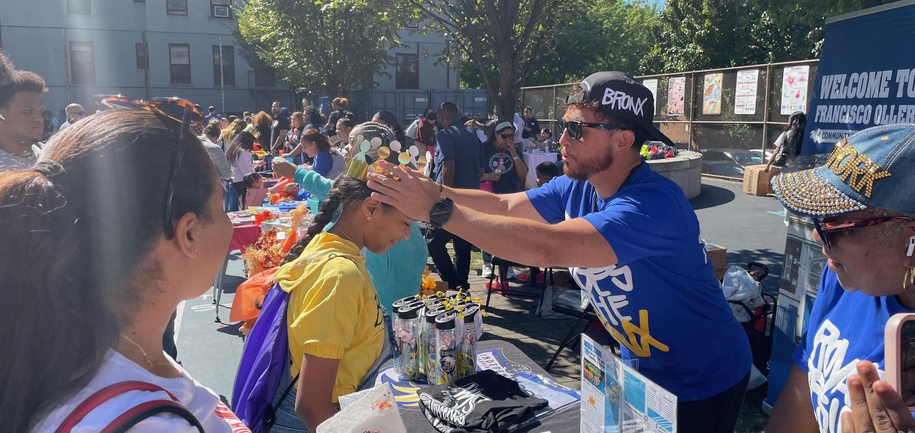Principal Reyes putting crown on a student's head