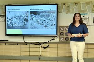 Presentation with a woman standing beside a screen displaying 'Conclusion'.