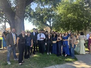 A group of Monache High School students and teachers, including Ramses Gomez and Bobby Styles, pose outdoors dressed formally for the Slick Rock Student Film Festival.