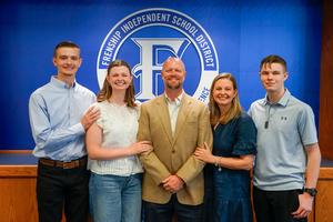 Joel and his family pose for a photo after the March 2026 school board meeting where Joel was recognized by the board.