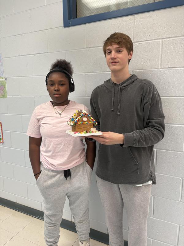 two students with gingerbread house