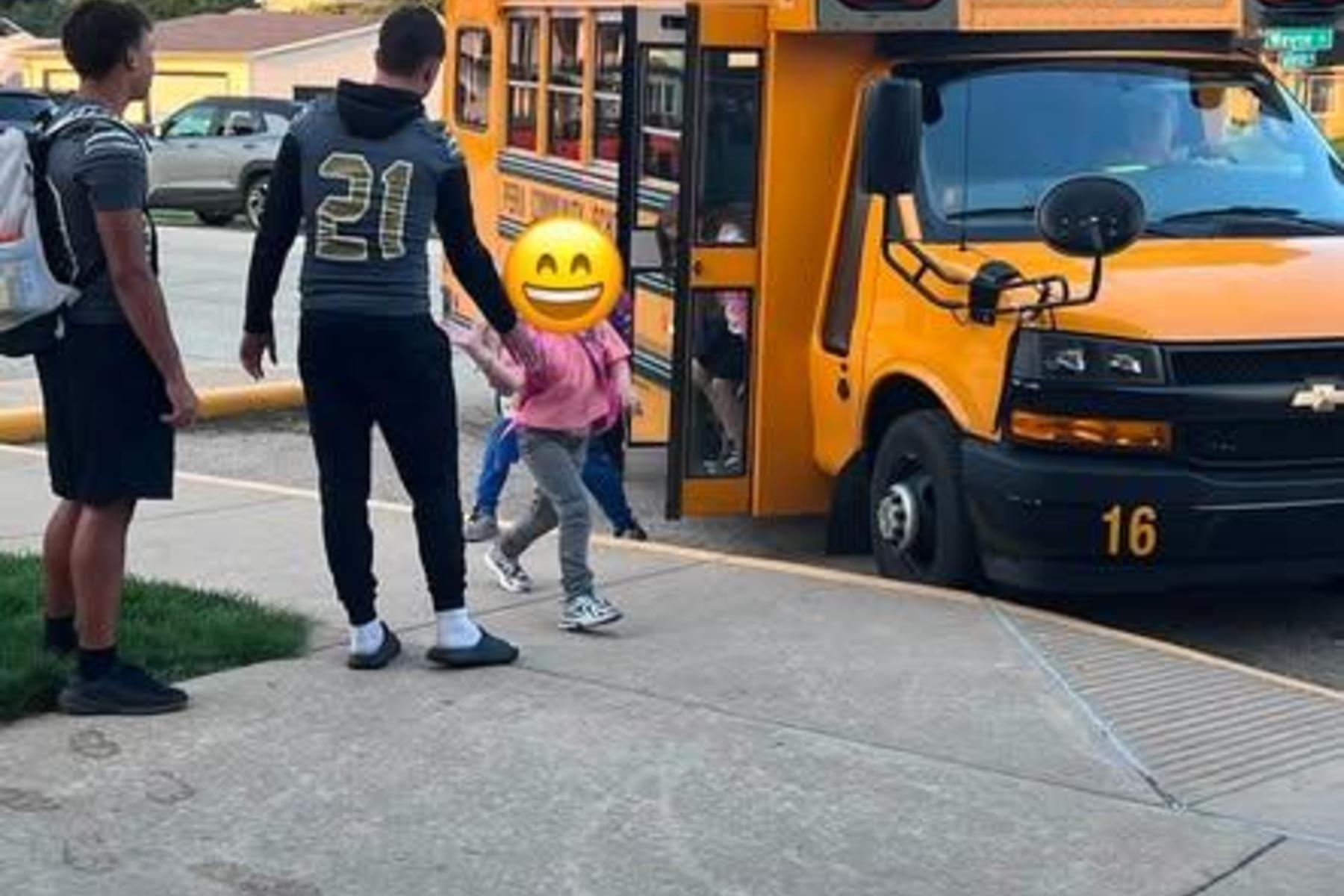 Football players greeting Elmwood students