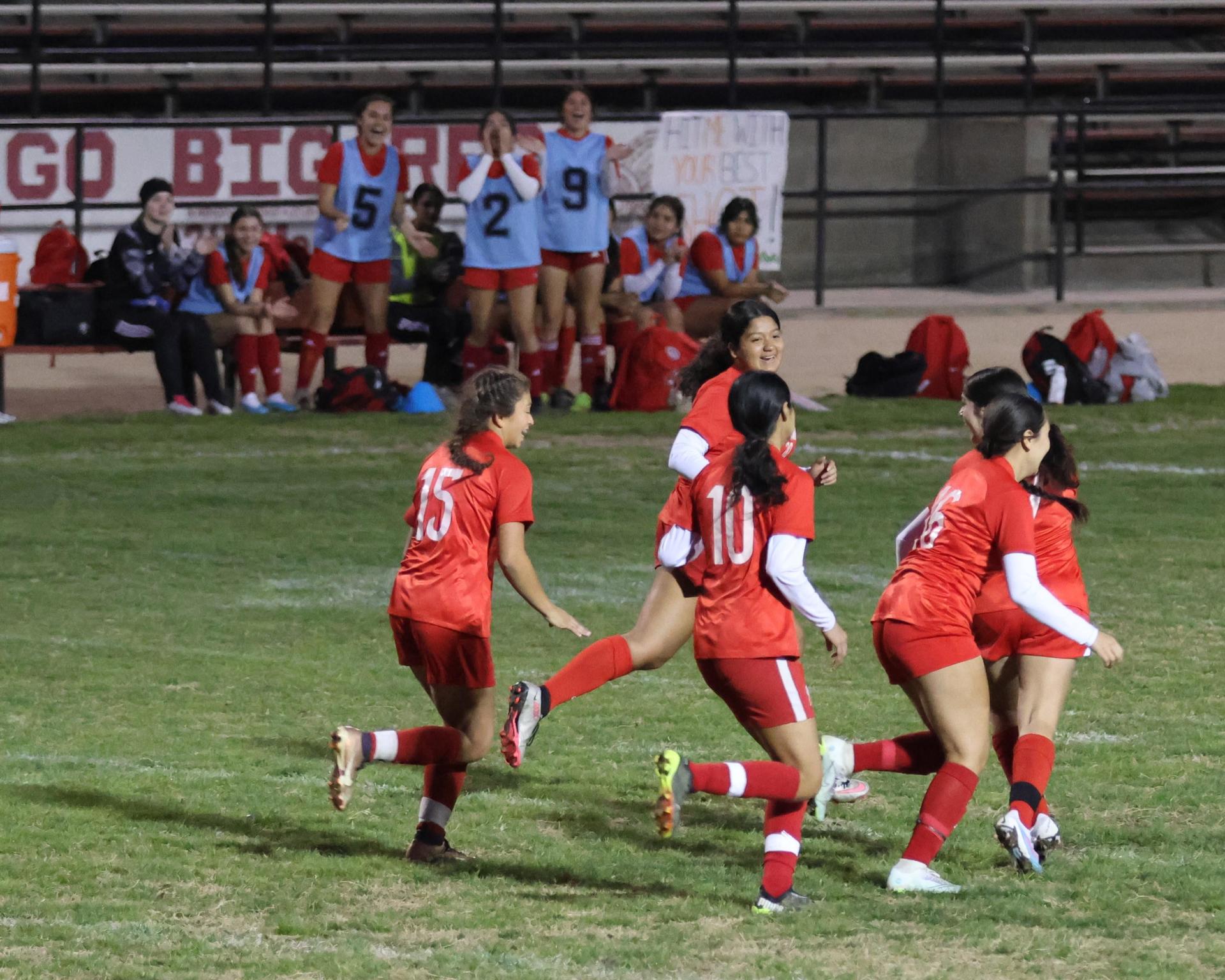 Varsity girls playing soccer against sunnyside
