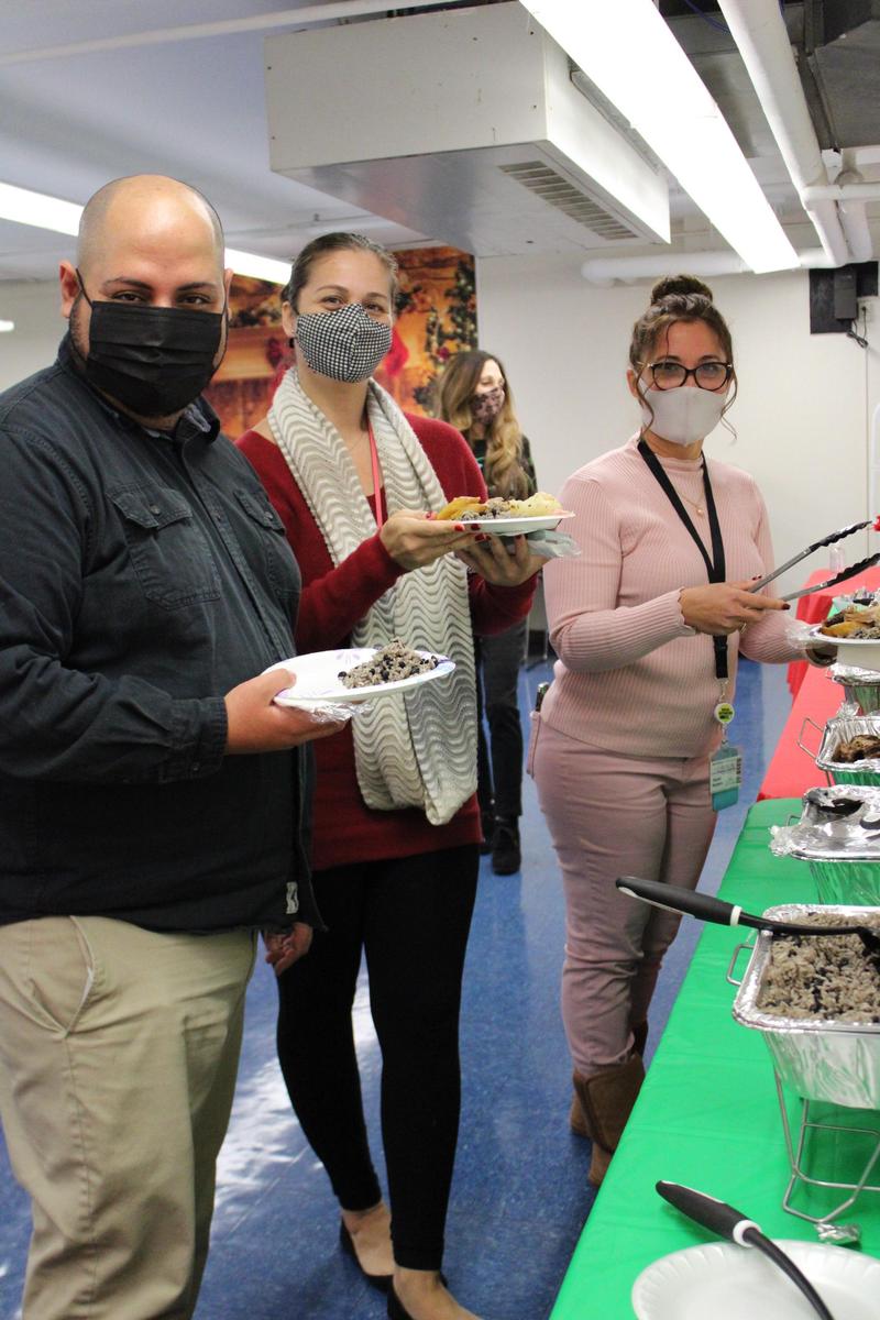 3 teachers posing with plates of food